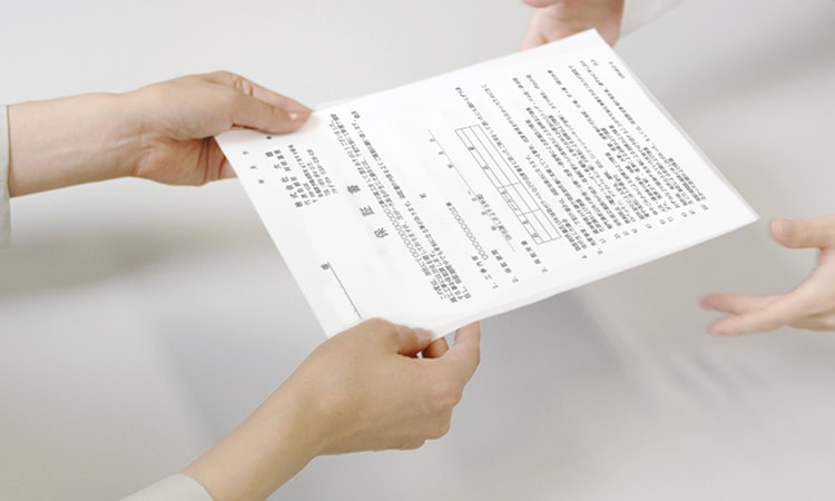 保証書の受け渡しをするシーン